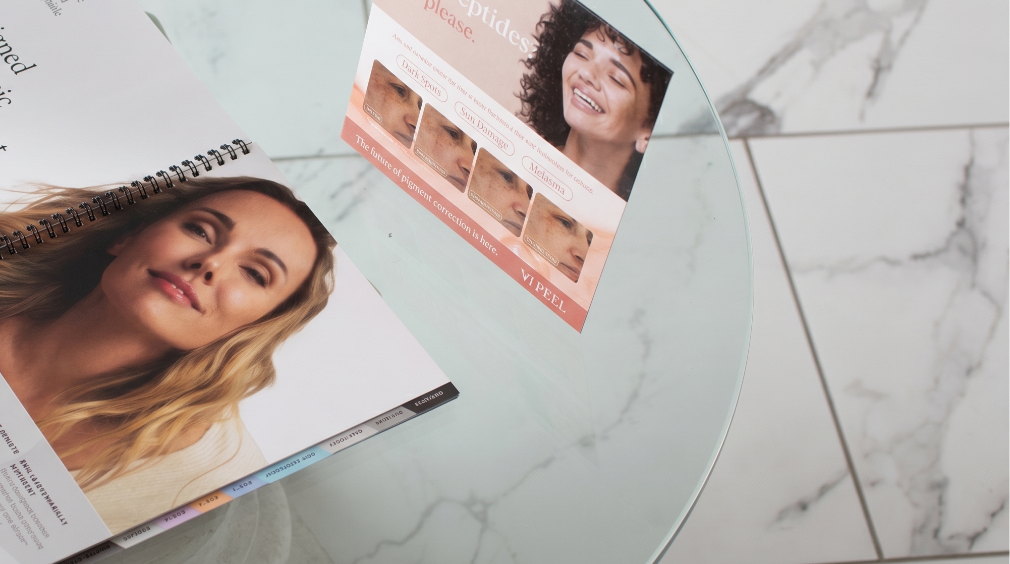 Two brochures on a glass table with a marble floor background