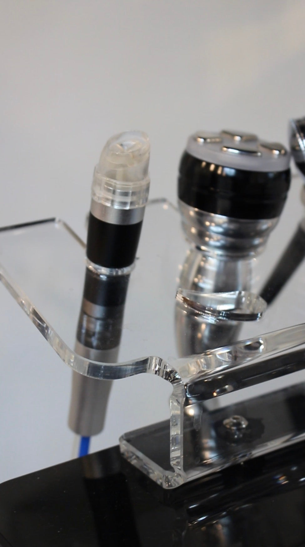 Close-up of a hydrofacial device with cylindrical components on a white background. Radiance at Fluhme Medspa, Pittsburgh, PA 