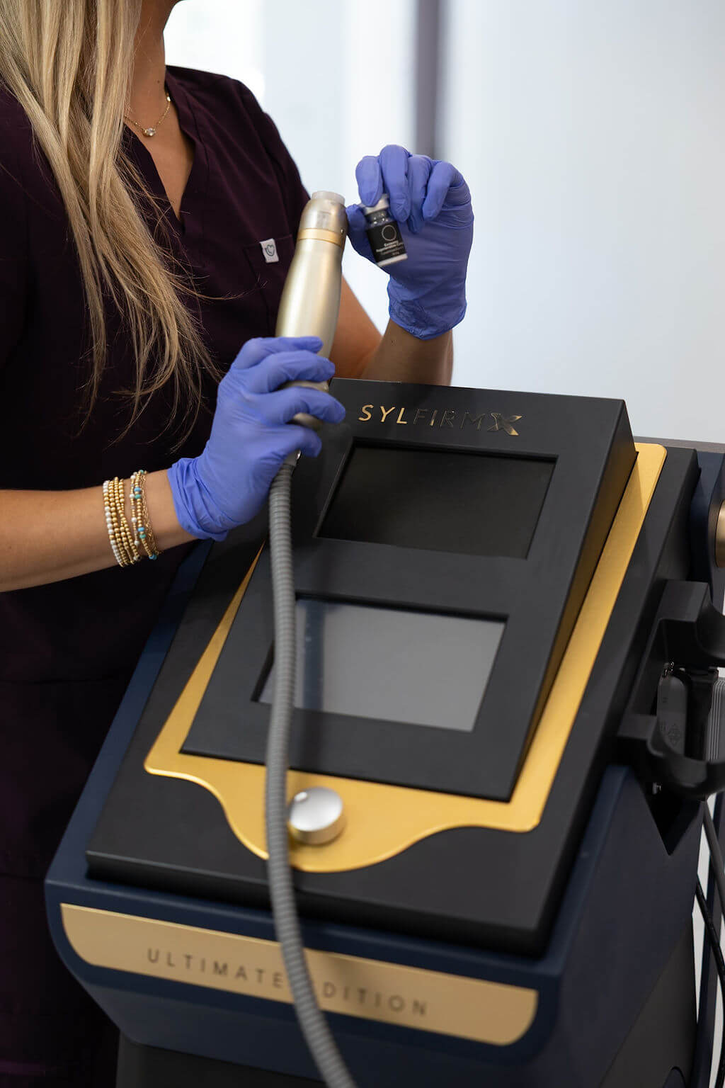 Person wearing gloves holding a device with 'Sylfirm X' branding.